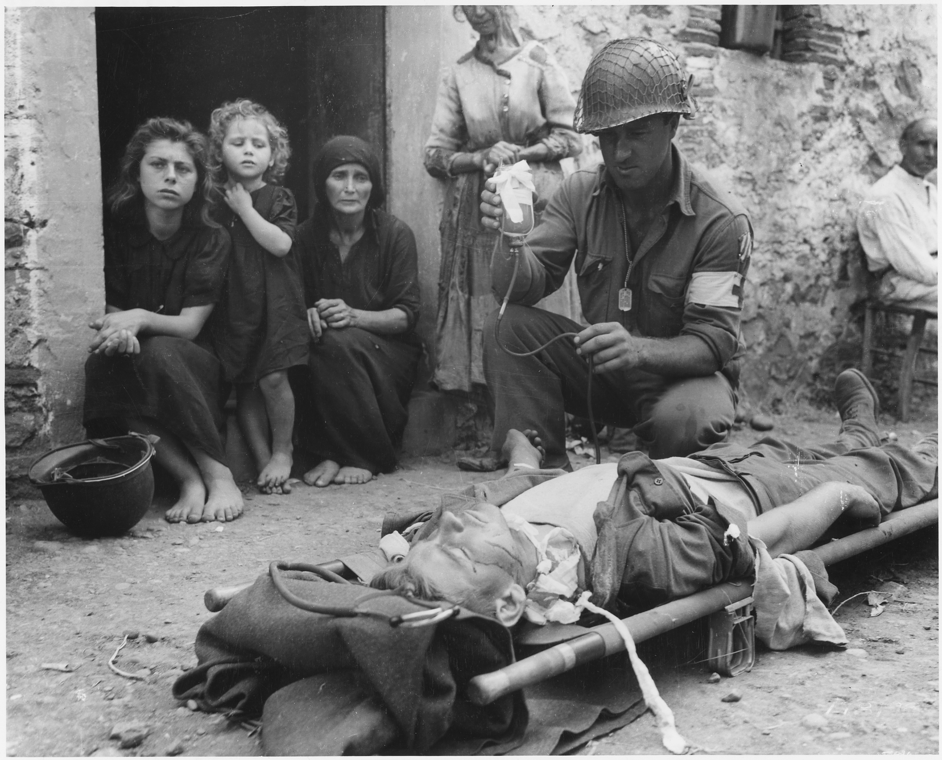 Private_Roy_W._Humphrey_of_Toledo%2C_Ohio_is_being_given_blood_plasma_after_he_was_wounded_by_shrapnel_in_Sicily_on_8-9-43_-_NARA_-_197268.jpg